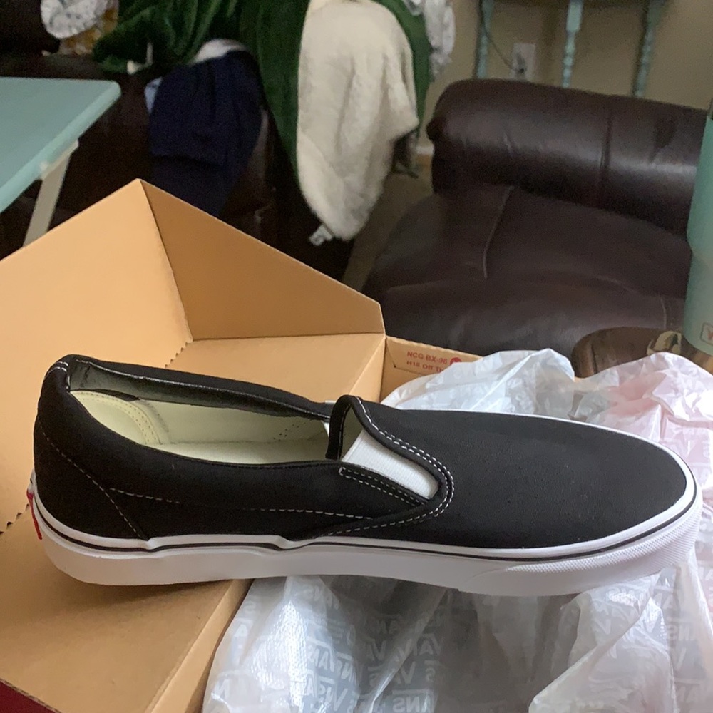 Vans New with Tags in Box.  Black Slip On. Women’s 12.5 = Men’s 11